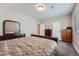Bedroom features plush carpet, a dresser with mirror, neutral paint, and natural lighting at 7693 S Quantock Way, Aurora, CO 80016
