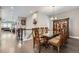 Open floor plan showcasing dining room and furniture, with a view into the living room at 7693 S Quantock Way, Aurora, CO 80016