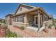 Charming home exterior with a cozy porch, grill, and landscaped garden, creating a welcoming entrance at 7693 S Quantock Way, Aurora, CO 80016