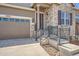 Attractive entryway and garage of this charming home with brick and siding exterior elements at 7693 S Quantock Way, Aurora, CO 80016