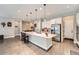 Bright kitchen with stainless steel appliances, white cabinets, and a large island at 7693 S Quantock Way, Aurora, CO 80016