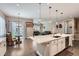 The open-concept kitchen flows into a sunny breakfast nook and living room at 7693 S Quantock Way, Aurora, CO 80016