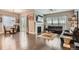 Spacious living room featuring hardwood floors, fireplace, and large windows for natural light at 7693 S Quantock Way, Aurora, CO 80016