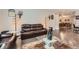 Cozy living room showcasing hardwood floors and leather sofas in an elegant setting at 7693 S Quantock Way, Aurora, CO 80016