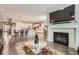 Open-concept living area with fireplace and TV, flowing into a modern kitchen at 7693 S Quantock Way, Aurora, CO 80016