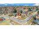 Stunning aerial view of the home with mountain views, solar panels, and a spacious front yard with mature trees at 6545 Union St, Arvada, CO 80004