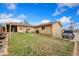 Large backyard with a grassy area, a rustic fire pit, and a covered patio, ideal for outdoor living at 6545 Union St, Arvada, CO 80004