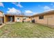 Spacious backyard with a grassy lawn, a charming fire pit, and a covered patio area at 6545 Union St, Arvada, CO 80004