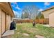 Serene backyard featuring lush grass, a unique fire pit, and a grill, perfect for outdoor gatherings at 6545 Union St, Arvada, CO 80004