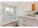 Bright bathroom featuring a stylish vanity with marble countertop and a modern tiled shower with glass door at 6545 Union St, Arvada, CO 80004