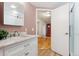 Well-lit bathroom featuring a marble countertop vanity and a modern shower with white subway tiles at 6545 Union St, Arvada, CO 80004