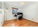 Bedroom with hardwood floors offers a dedicated workspace with a modern desk and ample natural light at 6545 Union St, Arvada, CO 80004