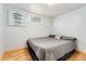 Cozy bedroom in the basement with a comfortable bed, small window, and neutral decor at 6545 Union St, Arvada, CO 80004