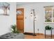 Inviting entryway featuring a stylish light fixture, wood door, and a decorative plant, creating a warm welcome at 6545 Union St, Arvada, CO 80004