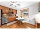 Charming kitchen with updated appliances, wood cabinets, and a cozy dining area with natural light at 6545 Union St, Arvada, CO 80004