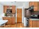 Well-equipped kitchen featuring stainless steel appliances, wood cabinets, and a modern backsplash at 6545 Union St, Arvada, CO 80004