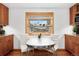 Bright eat-in kitchen showcasing wood cabinets, granite countertops, and a breakfast nook at 6545 Union St, Arvada, CO 80004