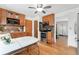 Eat-in kitchen features wood cabinetry, updated appliances, and plenty of natural light at 6545 Union St, Arvada, CO 80004