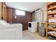 Functional laundry room with a washer, dryer, and built-in shelves for organized storage at 6545 Union St, Arvada, CO 80004