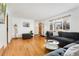 Spacious living room with hardwood floors, a comfortable sectional sofa, and ample natural light at 6545 Union St, Arvada, CO 80004