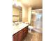 Bathroom featuring marble vanity, toilet, and glass shower with tile flooring at 13890 E Marina Dr # 602, Aurora, CO 80014