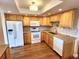 A well-lit kitchen featuring wood cabinets, granite countertops, and laminate flooring at 13890 E Marina Dr # 602, Aurora, CO 80014