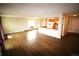 Bright, open-concept living space with wood flooring and neutral walls, adjacent to the kitchen area with updated appliances at 13890 E Marina Dr # 602, Aurora, CO 80014