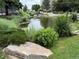 A tranquil pond surrounded by lush greenery and decorative rocks in a serene outdoor setting at 13890 E Marina Dr # 602, Aurora, CO 80014