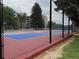 Outdoor tennis court with a colorful playing surface, enclosed by a tall chain-link fence at 13890 E Marina Dr # 602, Aurora, CO 80014