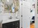 Charming powder room featuring stylish floral wallpaper and a modern vanity at 8450 E 29Th Ave, Denver, CO 80238