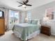 Inviting bedroom with floral curtains, two windows, and warm lamps on the nightstands at 8450 E 29Th Ave, Denver, CO 80238