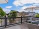 A relaxing deck with comfortable seating and neighborhood views, shaded by a large umbrella at 8450 E 29Th Ave, Denver, CO 80238