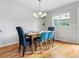 Bright dining room with wood floors, modern chandelier, and a large window view at 8450 E 29Th Ave, Denver, CO 80238