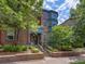 Beautiful brick home with landscaped front yard, covered porch, and eye-catching blue trim at 8450 E 29Th Ave, Denver, CO 80238