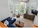 Bright and open living room with a ceiling fan, comfortable seating, and large windows at 8450 E 29Th Ave, Denver, CO 80238