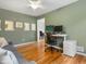 Bright office space with hardwood floors, natural light, and a modern adjustable desk at 8450 E 29Th Ave, Denver, CO 80238