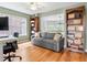 Cozy home office with hardwood floors, pull out sofa, and ample storage with built in shelving at 8450 E 29Th Ave, Denver, CO 80238