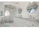 Bright bathroom featuring a marble topped vanity, mosaic tiled backsplash, and glass enclosed shower at 2518 N State Highway 67, Sedalia, CO 80135