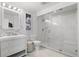 Bright bathroom features a stylish vanity, modern fixtures, and glass enclosed marble shower at 2518 N State Highway 67, Sedalia, CO 80135