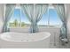 Bright bathroom featuring a soaking tub and stunning mountain views at 2518 N State Highway 67, Sedalia, CO 80135