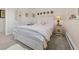 Bright bedroom with an accent mirror, floral bedding, and a quaint bedside table at 2518 N State Highway 67, Sedalia, CO 80135