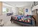 Comfortable bedroom with a large bed, colorful quilt, and scenic views from the windows at 2518 N State Highway 67, Sedalia, CO 80135