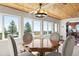 A dining room area featuring views, a wood ceiling, and updated lighting, leading into the kitchen at 2518 N State Highway 67, Sedalia, CO 80135
