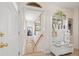 Welcoming foyer with decorative bench, coat hooks, and stairs leading to the lower level at 2518 N State Highway 67, Sedalia, CO 80135