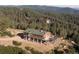 Wonderful exterior featuring a hilltop home embraced by lush greenery, complemented by mountain views at 2518 N State Highway 67, Sedalia, CO 80135