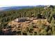 Scenic exterior showcasing a hilltop home with a deck surrounded by majestic pines and scenic mountain views at 2518 N State Highway 67, Sedalia, CO 80135