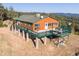 Charming home featuring an expansive outdoor deck with BBQ, outdoor seating, and scenic mountain views at 2518 N State Highway 67, Sedalia, CO 80135