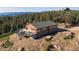 Charming log home nestled among trees, featuring an outdoor deck and a scenic mountain backdrop at 2518 N State Highway 67, Sedalia, CO 80135