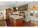 Kitchen area with stone fireplace, hardwood floors, stainless appliances and granite countertops at 2518 N State Highway 67, Sedalia, CO 80135