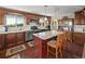 A kitchen featuring granite countertops, stainless steel appliances, wooden cabinetry and an island with barstool seating at 2518 N State Highway 67, Sedalia, CO 80135